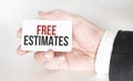 businessman holding a card with text FREE ESTIMATES