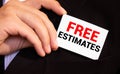 businessman holding a card with text FREE ESTIMATES