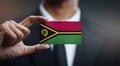 Businessman Holding Card of Vanuatu Flag