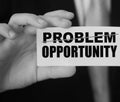 Businessman holding a card with word Problem strikeout and Opportunity. Problem turns into Opportunity. Business crisis management Royalty Free Stock Photo