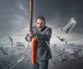 Businessman holding a carrot in a stick Royalty Free Stock Photo