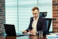Businessman holding a cell phone and writing sms message in office,businessman use mobile smart phone,Close up of a man using mob Royalty Free Stock Photo