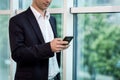 Businessman holding a cell phone and writing sms message in office,businessman use mobile smart phone,Close up of a man using mob Royalty Free Stock Photo