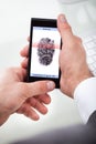 Businessman holding cellphone scanning finger Royalty Free Stock Photo
