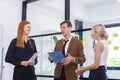 Businessman holding clipboard hands talking meeting with businesswoman in coworking office. businessperson brainstorming strategy