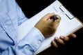 Businessman holding a Clipboard and writing the check list after