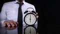 Businessman Holding Clock Pointing at Six O& x27;Clock Royalty Free Stock Photo