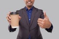 Businessman Holding Coffee To Go Cup Showing Thumb Up Isolated Close Up. Indian Business man with Coffee Take Away Cup