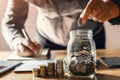 businessman holding coins putting in glass. concept saving money and finance Royalty Free Stock Photo