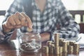 Businessman holding coins putting in glass. concept saving money for finance accounting, coin stack growing business, save money Royalty Free Stock Photo