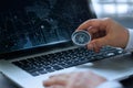 Businessman holding compass with searching screen laptop