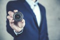 Businessman holding compass showing direction concept for guidance