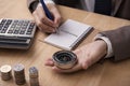 Businessman holding compass and writeing direction finance plan Royalty Free Stock Photo