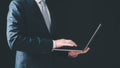 businessman holding computer laptop typing on keyboard email, communication, online coding.