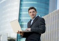 Businessman holding computer laptop working outdoors Royalty Free Stock Photo