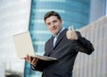 Businessman holding computer laptop working urban business outdoors Royalty Free Stock Photo