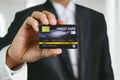 Businessman holding credit card mockup . Plastic bank-card design mock up