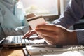 Businessman holding credit card and using laptop. Making payment while online shopping. E-commerce and modern technology concept Royalty Free Stock Photo