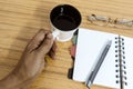 Businessman holding a cup of coffee. Business pocket planner with a eyeglass and a pen ready to note an appointment. Business Royalty Free Stock Photo