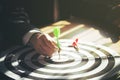 Businessman holding dart attached to target on dartboard Royalty Free Stock Photo