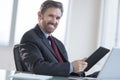 Businessman Holding Digital Tablet At Desk Royalty Free Stock Photo