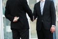 Businessman Holding Dollars While Shaking Hands With Partner Royalty Free Stock Photo