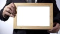 Businessman holding empty blackboard template for your text, advertising Royalty Free Stock Photo