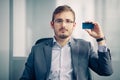 Businessman holding empty business card in the office Royalty Free Stock Photo