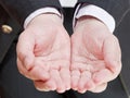 Businessman holding empty handful from two palms Royalty Free Stock Photo