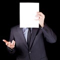 Businessman holding an empty sheet of paper in front of his face