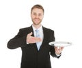 Businessman holding empty tray over white background Royalty Free Stock Photo