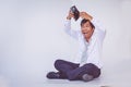 Businessman holding empty wallet sitting on the floor Royalty Free Stock Photo