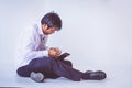 Businessman holding empty wallet sitting on the floor Royalty Free Stock Photo