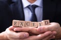 Businessman Holding Exceed Expectations Word