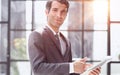 Portrait of a handsome young business man holding document folder Royalty Free Stock Photo