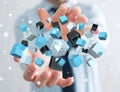 Businessman holding floating blue shiny cube network 3D rendering Royalty Free Stock Photo