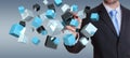 Businessman holding floating blue shiny cube network 3D rendering Royalty Free Stock Photo