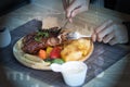 Businessman holding fork and knife eating steak, business and food/restaurant concept Royalty Free Stock Photo