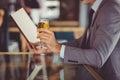 Businessman holding glass of beer and looking at menu Royalty Free Stock Photo