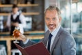 Businessman holding glass of beer and menu Royalty Free Stock Photo