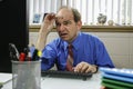 Businessman holding glasses and looking at computer, horizontal Royalty Free Stock Photo