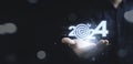 Businessman holding glowing 2024 with dartboard and arrow for setup new business objective target and goal since new year concept