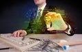 Businessman holding glowing glass light bulb