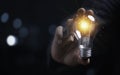 Businessman holding glowing light bulb for creative thinking ideas and innovation concept Royalty Free Stock Photo