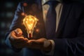 Businessman holding a glowing light bulb in his hand on abstract background, Businessman\'s hand holding a light Royalty Free Stock Photo