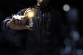 Businessman holding glowing lightbulb with orange light . Creative new business idea concept