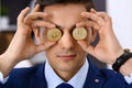 Businessman holding golden bitcoin and smiling. Virtual anonymous money concept, success in digital finance Royalty Free Stock Photo