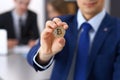 Businessman holding golden bitcoin and smiling. Virtual anonymous money concept, success in digital finance Royalty Free Stock Photo