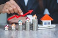 Businessman Holding  Graph Over The Increasing House Miniature, Real estate investment,investment mortgage finance and home loan Royalty Free Stock Photo