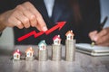 Businessman Holding  Graph Over The Increasing House Miniature, Real estate investment,investment mortgage finance and home loan Royalty Free Stock Photo